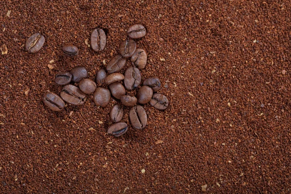 Ground coffee background and coffee beans