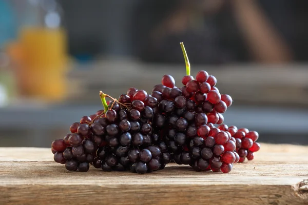 Red grapes on a wooden table