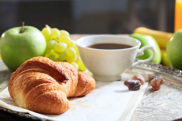 Coffee, croissant and fresh fruits