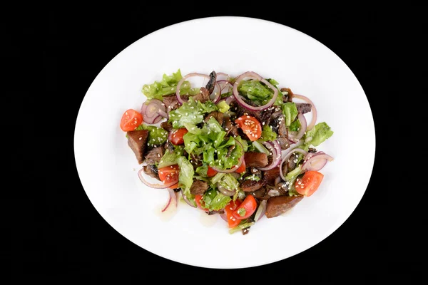 Salad with meet and vegetables on white plate