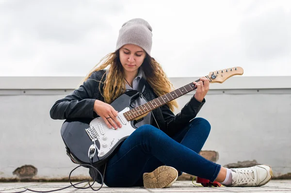 Beauty girl playing on guitar