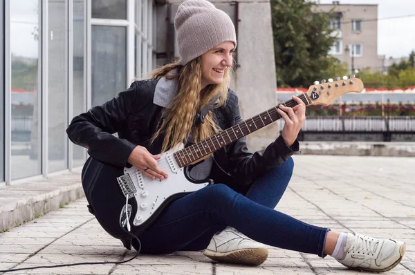 Beauty girl playing on guitar