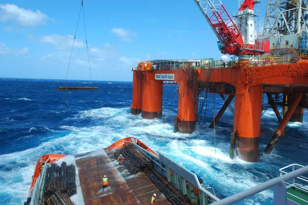 Big wave during unloading under semi submersible oil rig near South Africa. pipes on deck. real seaman job, danger, rough weather.critical list. danger. hard navigation. collision