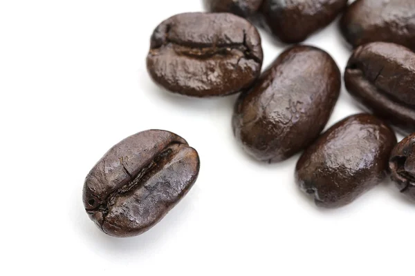 Close up of group of coffee beans isolated on white background