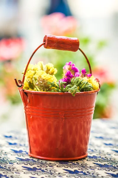 Old metal bucket with flowers