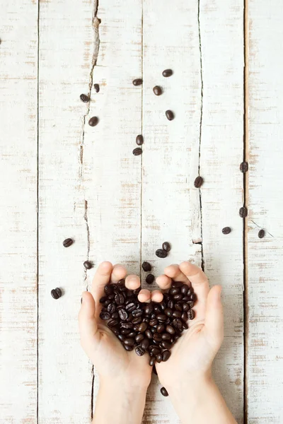 Coffee beans heart in hands