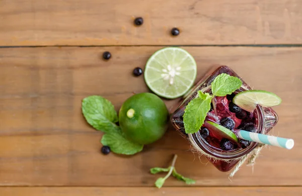 Summer drink with ingredients on wood