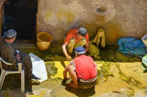 FEZ, MOROCCO, MAY 31, 2012- Workers in the Chouwara Tannery in the medina of Fez