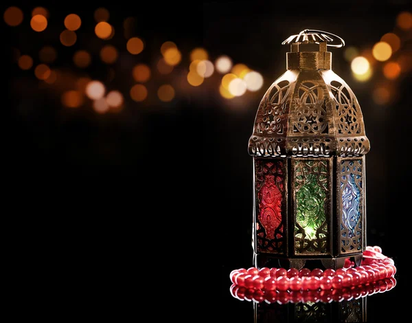 Vintage lantern with red rosary