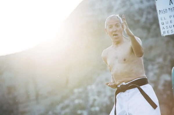 Older man practicing martial arts
