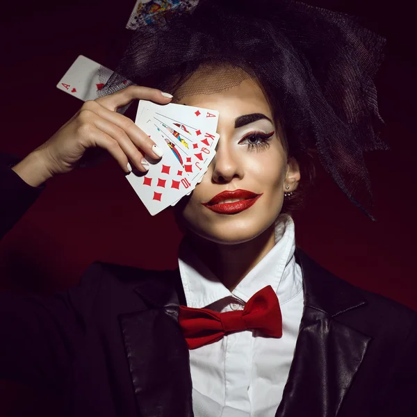 Portrait of a young beautiful lady croupier in an image of joker.