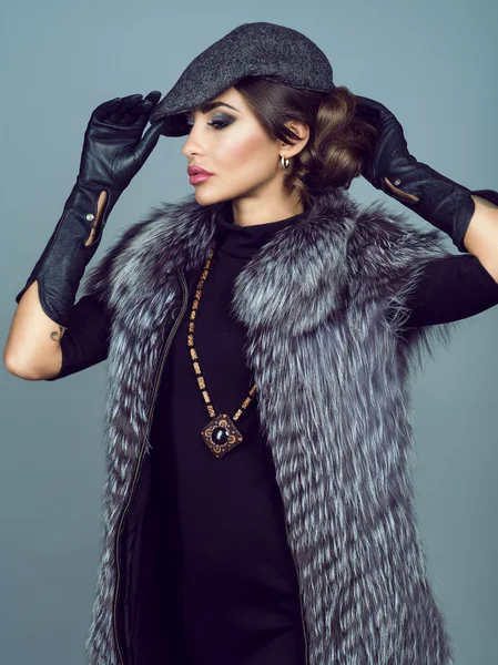 Portrait of a beautiful glam model wearing silver fox jacket.