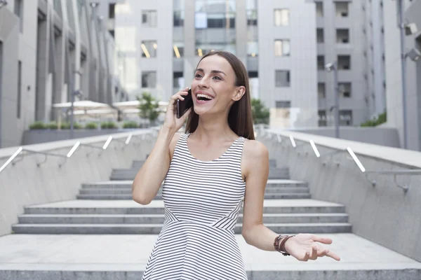 Business woman smiling and talking on the phone.