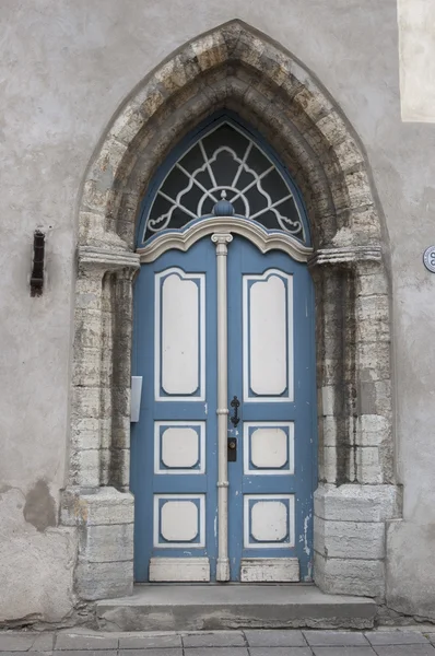 Ornate arched stone doorway in Tallinn, Estonia.