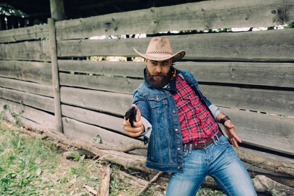 Bearded cowboy with gun