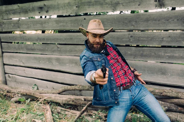 Bearded cowboy with gun