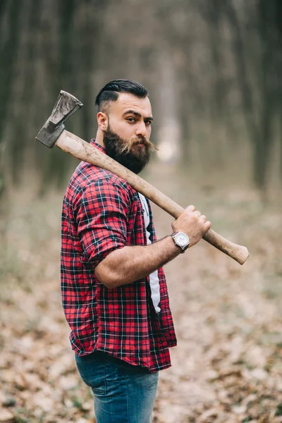 Bearded lumberjack in the woods