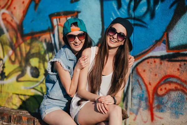 Young girls near graffiti wall