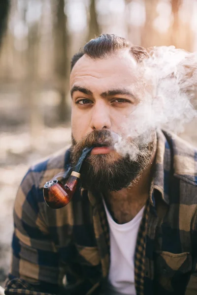 Bearded man smoking pipe