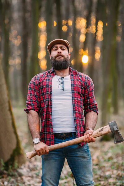 Bearded lumberjack in the woods