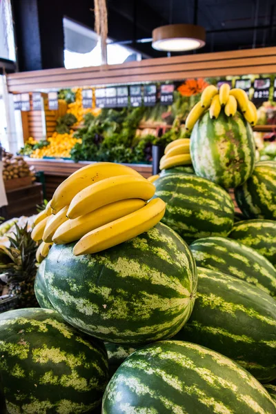 Bananas on the watermelons at the supermarket