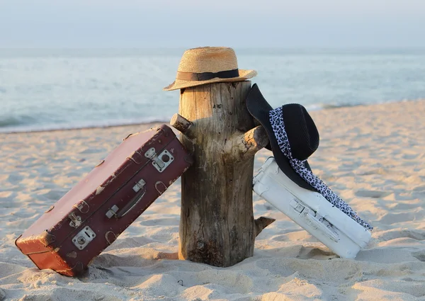 Suitcases old and hats on a stub