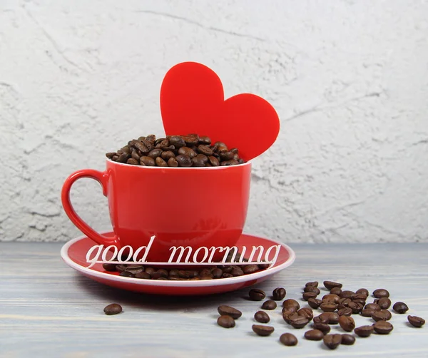 Cup red with coffee grains, heart and an inscription good morning