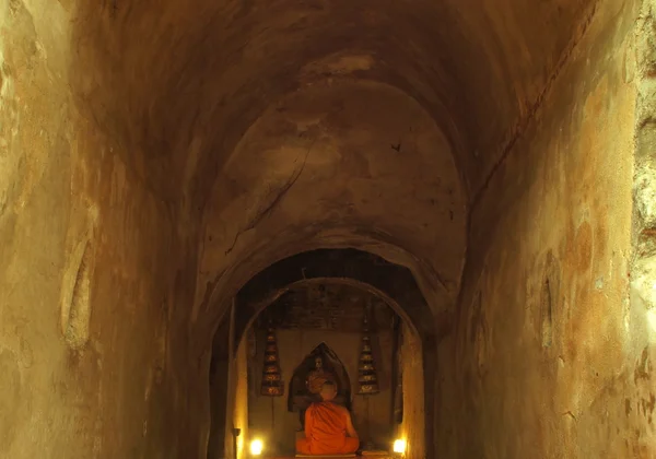 Buddhist monks meditating  in cave