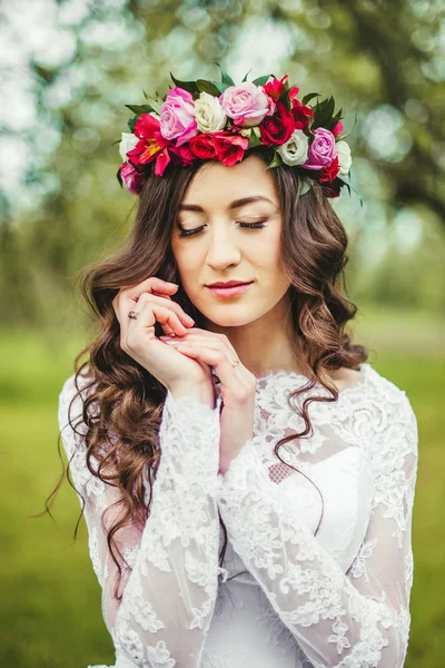 Bride in white dress in a garden