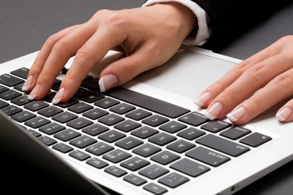 Office woman is holding two hands on the laptop keyboard