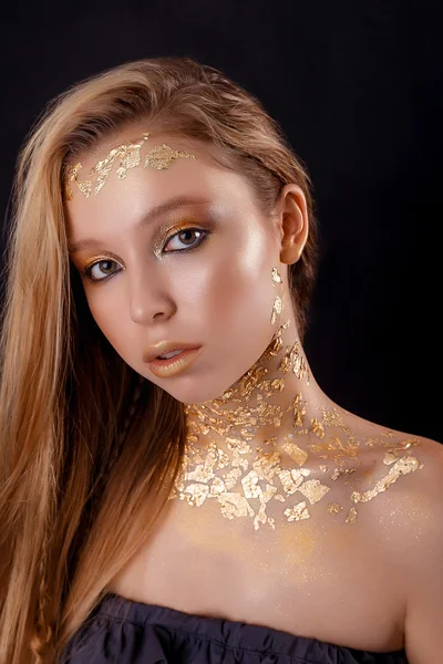 Beauty portrait of beautiful woman. gold portrait