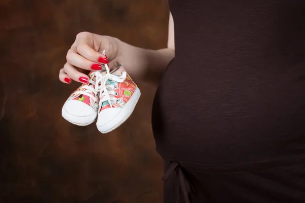 Close-up Image of pregnant woman touching her belly with hands