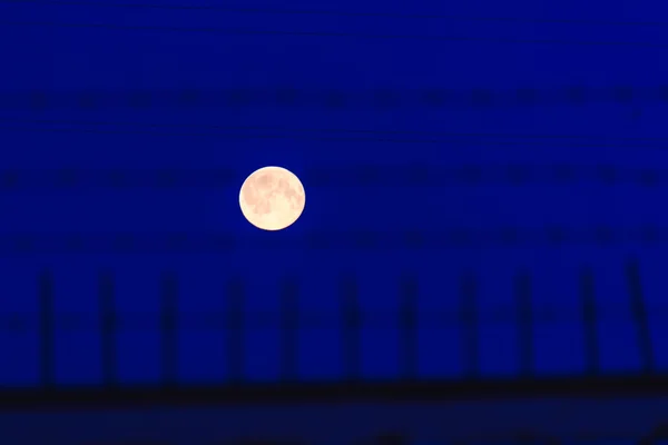Full moon behind bars