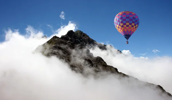 Hot air balloon over mountains