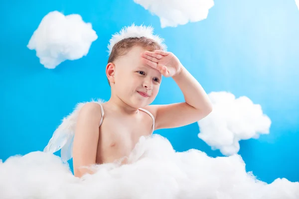 Boy Cupid sitting on a cloud with an arrow in hand