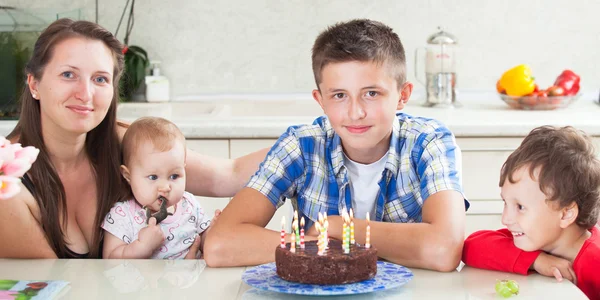 Teenager blows out the candles on a birthday cake