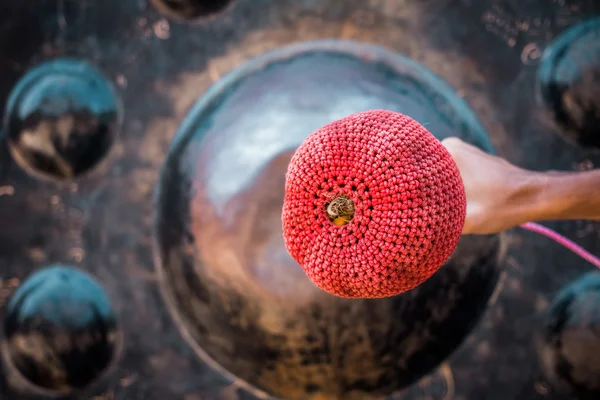 Hand hit big gong in temple