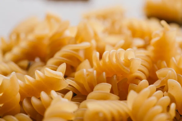 Dry Italian pasta on a dark mirror background