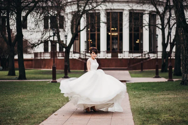 Beautiful woman posing in a wedding dress. wedding makeup and hairstyle, fashion bride model jewelry and beauty female face, bride in luxury wedding dress,