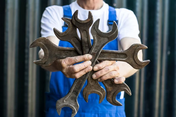 Mechanic holding a wrench.