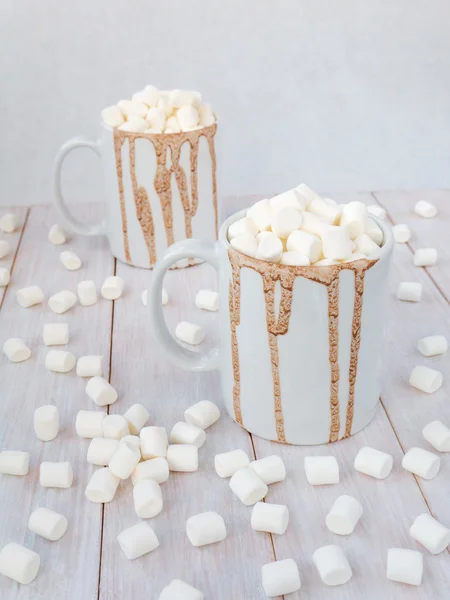 Hot chocolate in white mugs with drops
