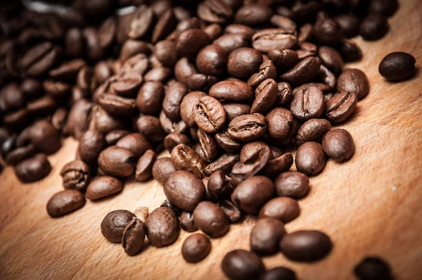 Grains of coffee on a wooden kitchen table