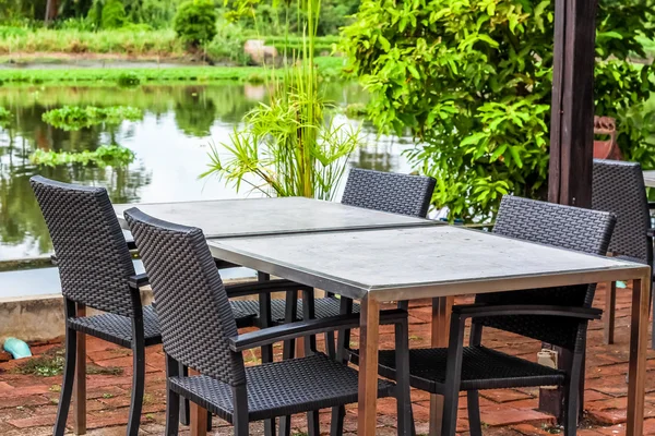 Classic table with four chairs beside the beautiful river