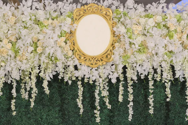 Backdrop with blank logo decorated with white flower and green leaf