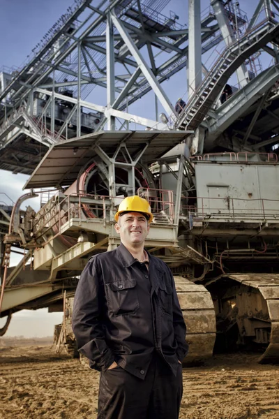 Man standing near bucket wheel excavator