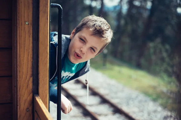 Boy looking out of train
