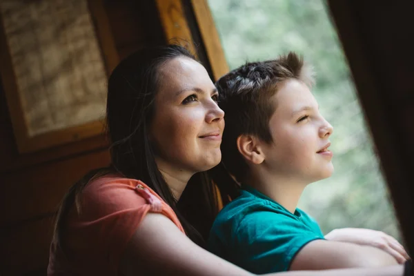 Mother and son looking in window