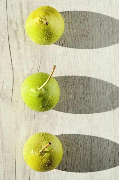 Three juicy green pear with water drops