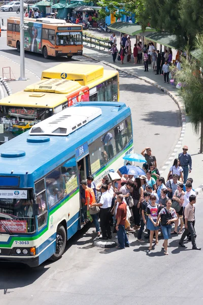 People waiting to getting on a bus.