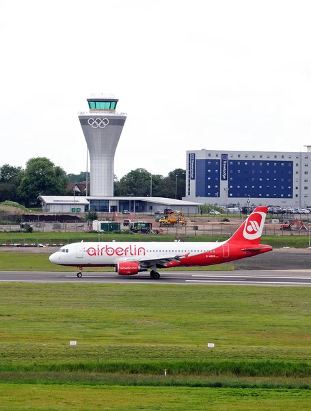 Air Berlin A320 D-ABDW taxiing after landing with the new control tower to the rear at Birmingham Airport, Birmingham, UK.